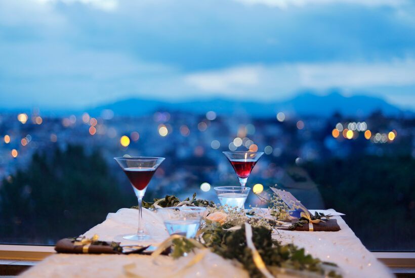 Glass of Drink by the Window with City Background at Night Beauty Army surprisingly fun date ideas during the pandemic